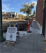 Construction along Grand Avenue: Pedestrian access/walkways and businesses open signage.