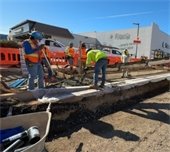 Construction of Grand Avenue. Workers laying concrete. 